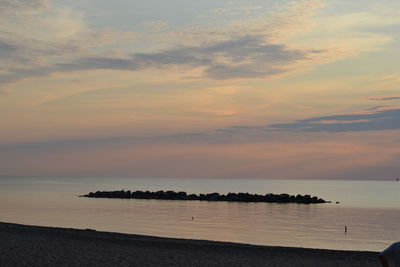 Scenic view of sea against sky at sunset