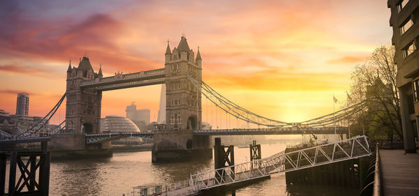 View of bridge over river at sunset