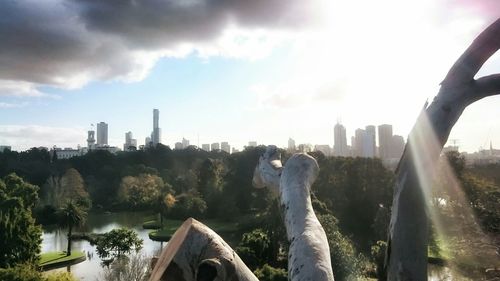 Skyscrapers against cloudy sky