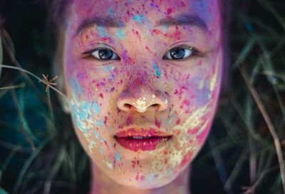 Portrait of a girl with paint splatters on face