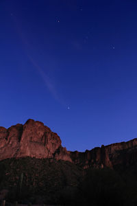 Scenic view of mountains against clear blue sky