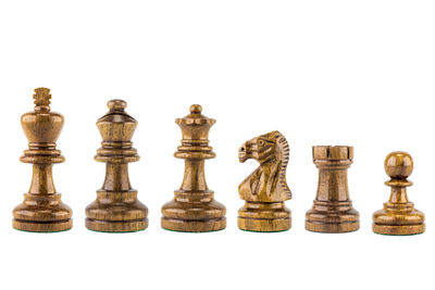 Low angle view of chess pieces against white background