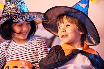 Portraits of a boy and a girl in halloween outfits. happy children