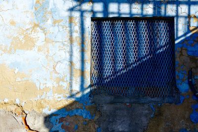 Window on the blue facade of the house, architecture in bilbao city, spain