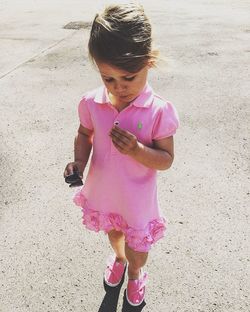 High angle view of girl standing on pink road