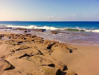 Scenic view of beach against clear sky