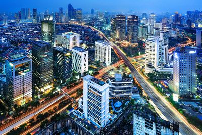 Aerial view of city lit up at night