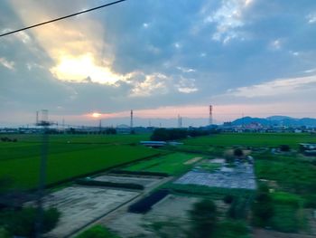 Scenic view of field against sky during sunset