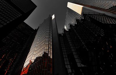 Low angle view of modern buildings against sky at night