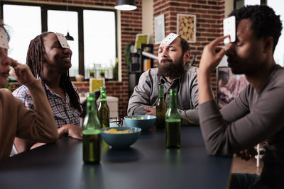 Business colleagues playing cards at office