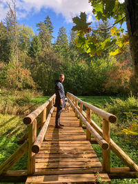 Full length of girl walking on footbridge