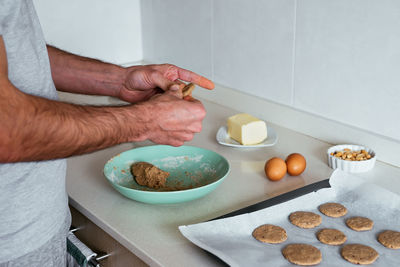 Young man making cookies at the kitchen