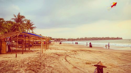 People on beach against sky