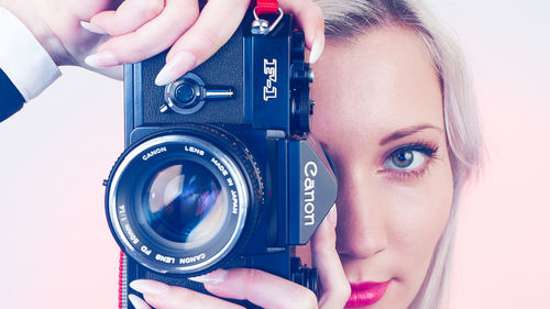 Portrait of woman photographing camera