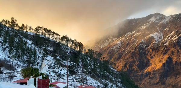 Scenic view of snow covered mountains against sky