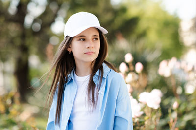 Portrait of young woman standing outdoors