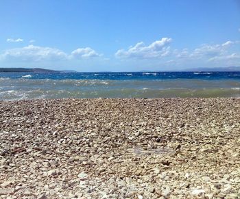 Scenic view of sea against cloudy sky