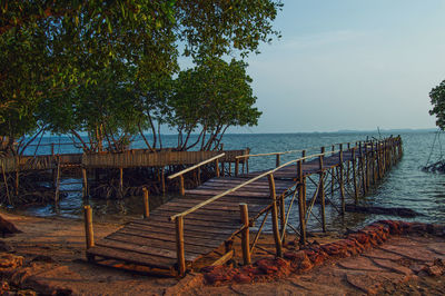 Pier over sea against sky