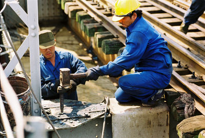 Rear view of men working
