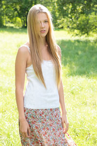 Portrait of beautiful teenage girl standing on field