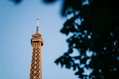 High section of eiffel tower against clear blue sky