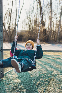 Girl playing on the swing at the park