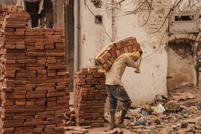 Man working on brick wall