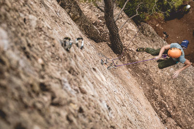 View from above of a girl falling while climbing.
