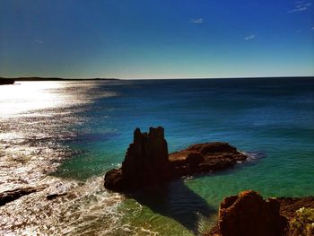 Scenic view of sea against clear blue sky