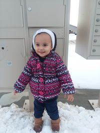 Portrait of cute girl standing in snow