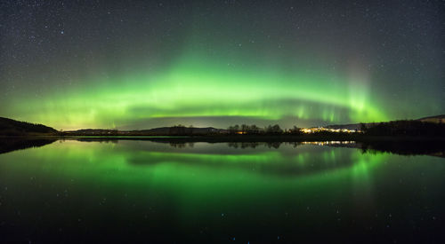 Scenic view of lake against sky at night