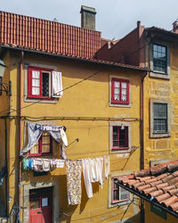 Clothes drying on residential buildings - tradicional houses in ribeira district, porto portugal 