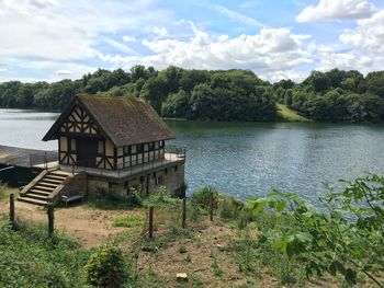 Calm lake with buildings in background