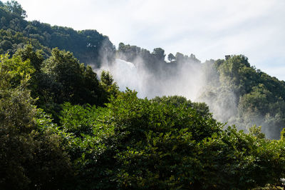 Scenic view of waterfall against sky