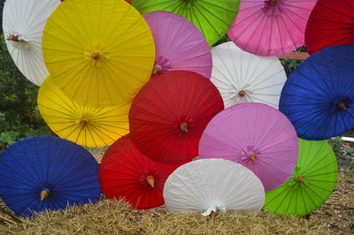 Multi colored open umbrellas on field