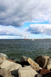 Scenic view of calm sea against cloudy sky