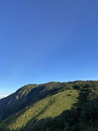 Scenic view of mountains against clear blue sky