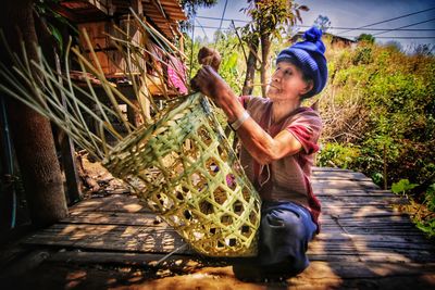 Full length of woman holding food on plant