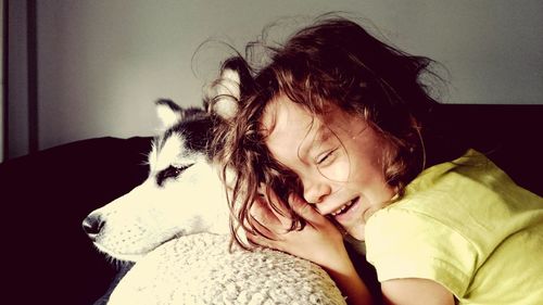 Close-up of woman sleeping on bed at home