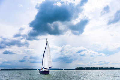 Sailing yacht in the lake with blue sky. yacht sailing on the lake against a blue sky