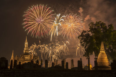 Firework display in city at night