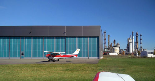 Airplane on runway against clear blue sky