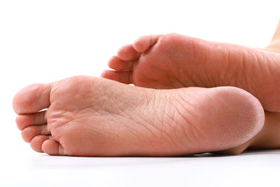 Close-up of hand holding hands over white background