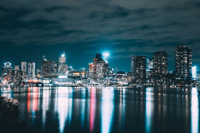 Illuminated city at waterfront at night