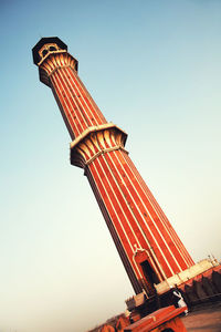 Low angle view of historic column against clear blue sky