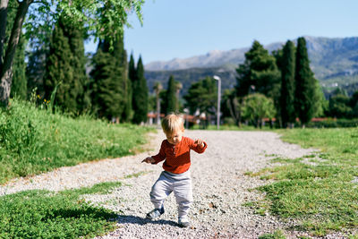 Full length of boy with arms raised