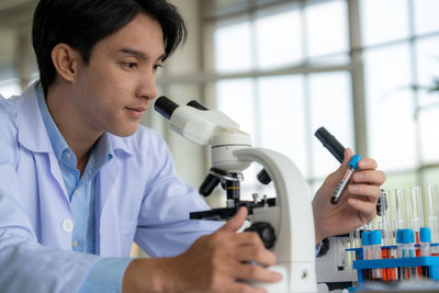 Side view of young woman using phone