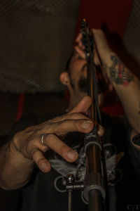 Low angle view of musician singing in microphone at nightclub