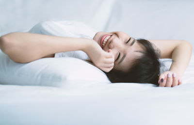 Woman lying on bed