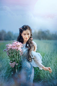 Young woman standing on field